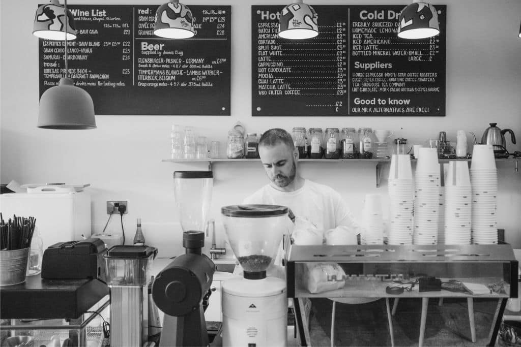 A photo of a man working in a coffee shop.